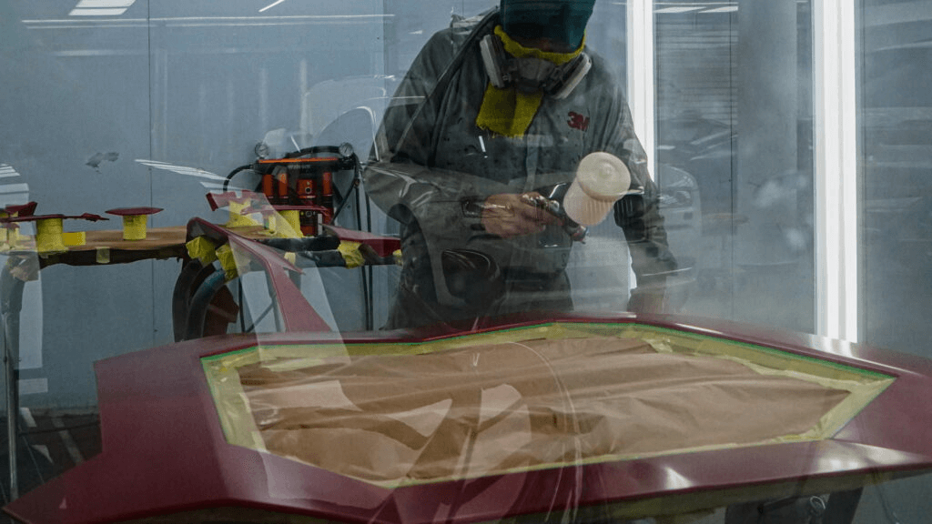 A person touching up the car paint